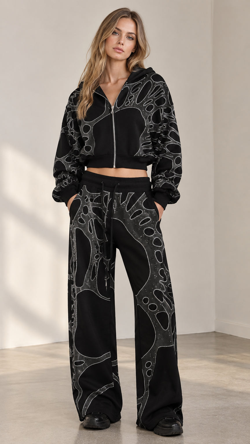 Front view of woman wearing black rhinestone cropped zip hoodie and wide leg sweatpants