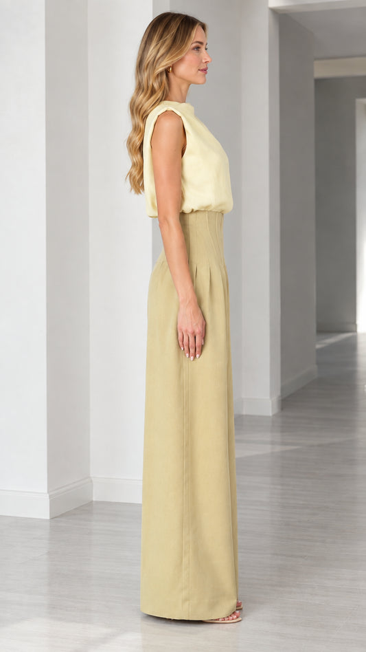 Side profile of model wearing high-waist wide-leg jumpsuit in butter yellow and khaki