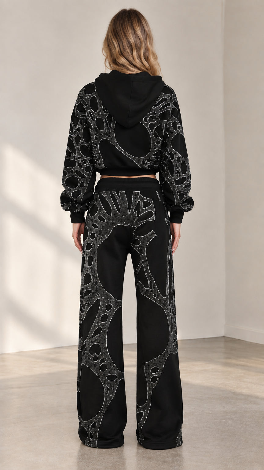 Back view of woman wearing black rhinestone cropped zip hoodie and matching wide leg sweatpants