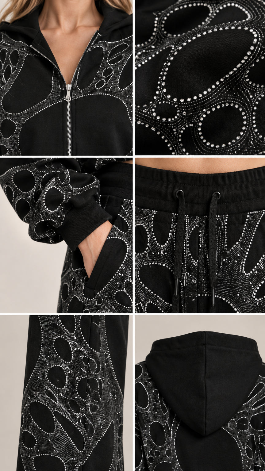 Close up details of rhinestone graphic zipper pockets and hood construction on black tracksuit