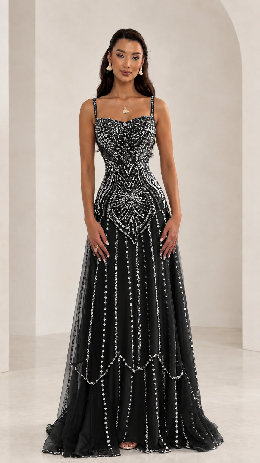 Front view of woman wearing Black sequin beaded sweetheart tulle evening gown