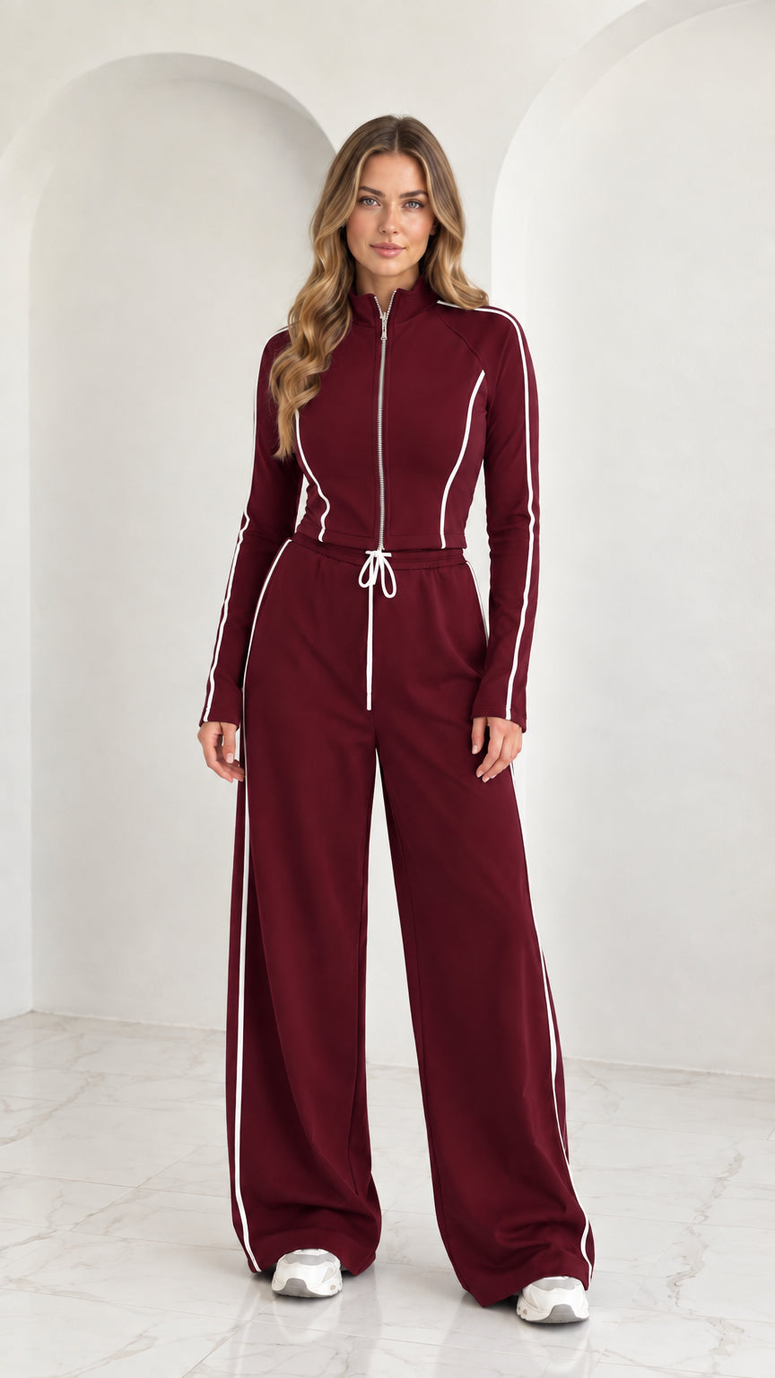 Full front view of model wearing Burgundy 2-piece zip-up tracksuit set with white piping