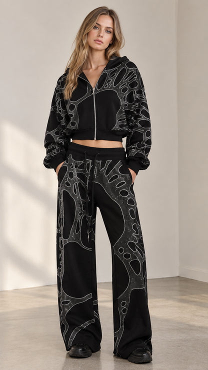 Front view of woman wearing black rhinestone cropped zip hoodie and wide leg sweatpants