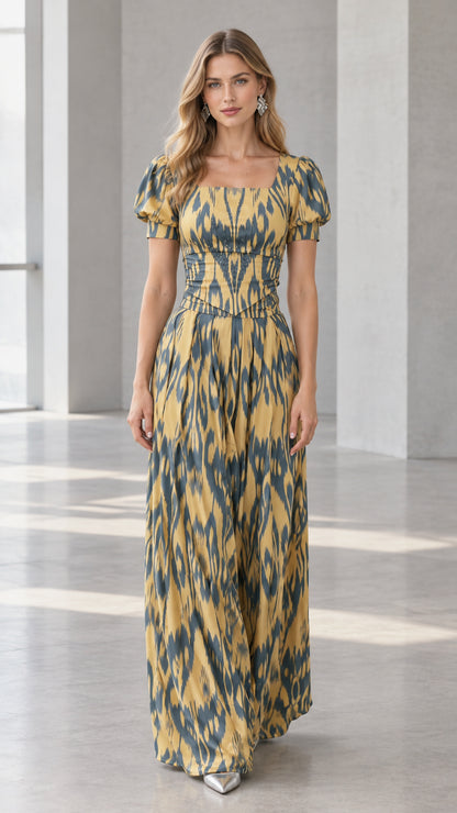Front full-length view of model wearing mustard yellow ikat print puff sleeve maxi dress