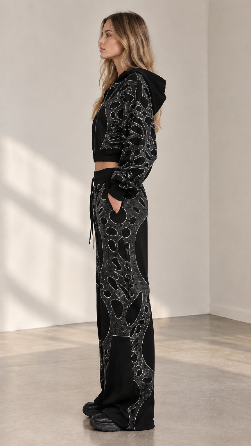 Side view of woman wearing black rhinestone cropped tracksuit set