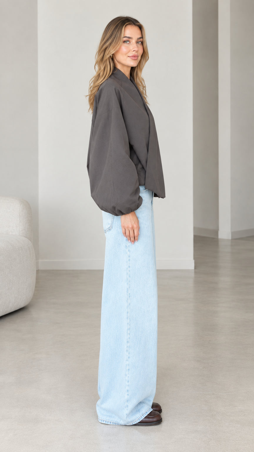 Side view of model wearing Dark Grey V-neck balloon sleeve top