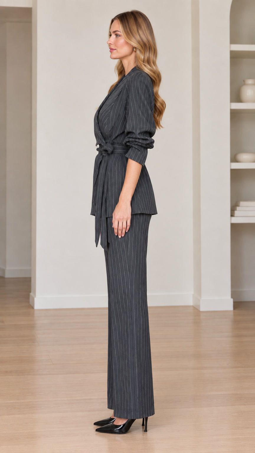 Side profile view of women's charcoal grey pinstripe two-piece suit