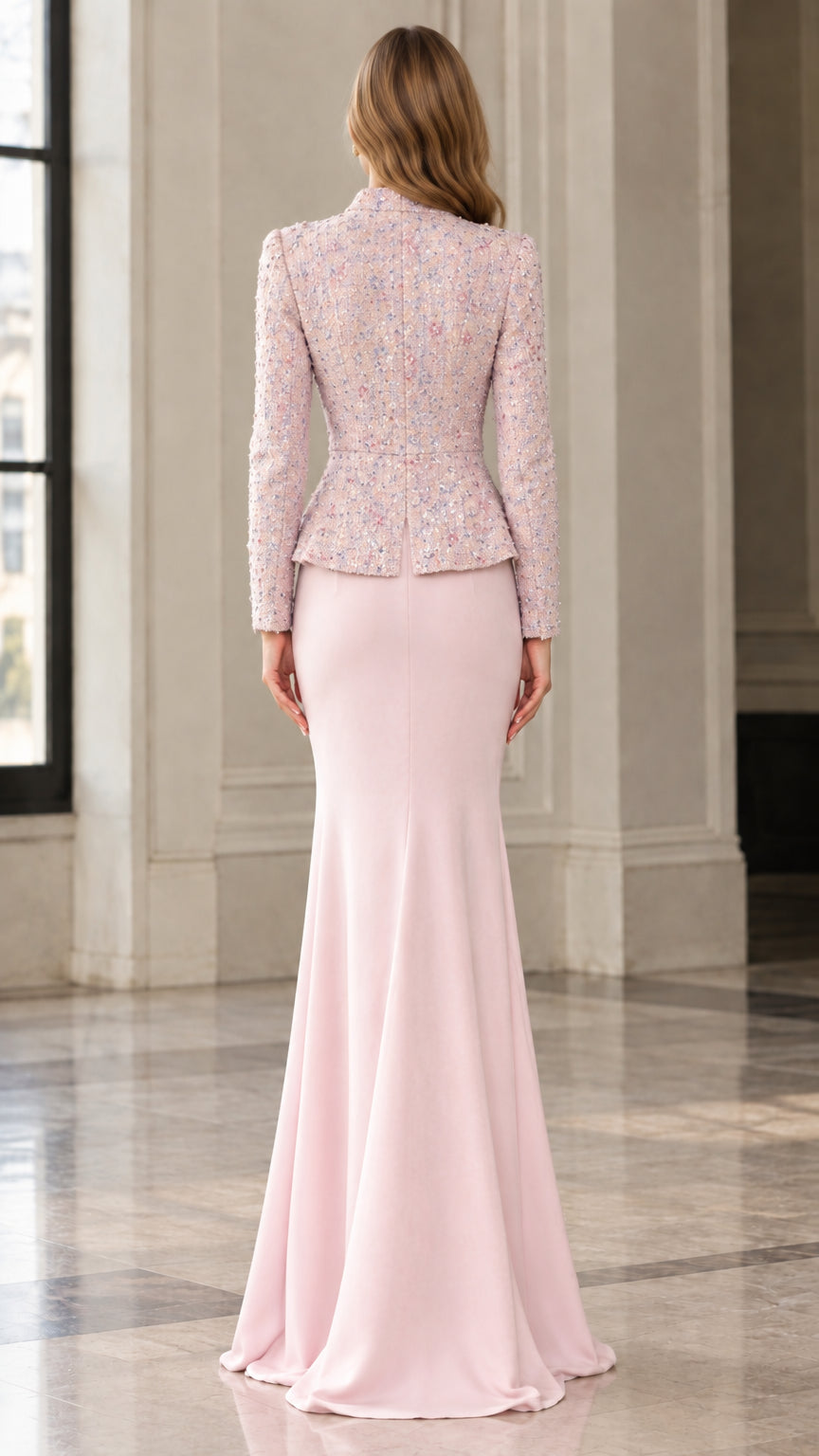 Back view of woman wearing blush pink peplum jacket and sweeping mermaid skirt