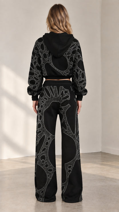 Back view of woman wearing black rhinestone cropped zip hoodie and matching wide leg sweatpants
