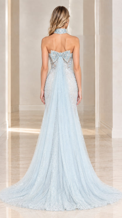 Back view of model wearing Light Blue evening gown featuring bow detail and train