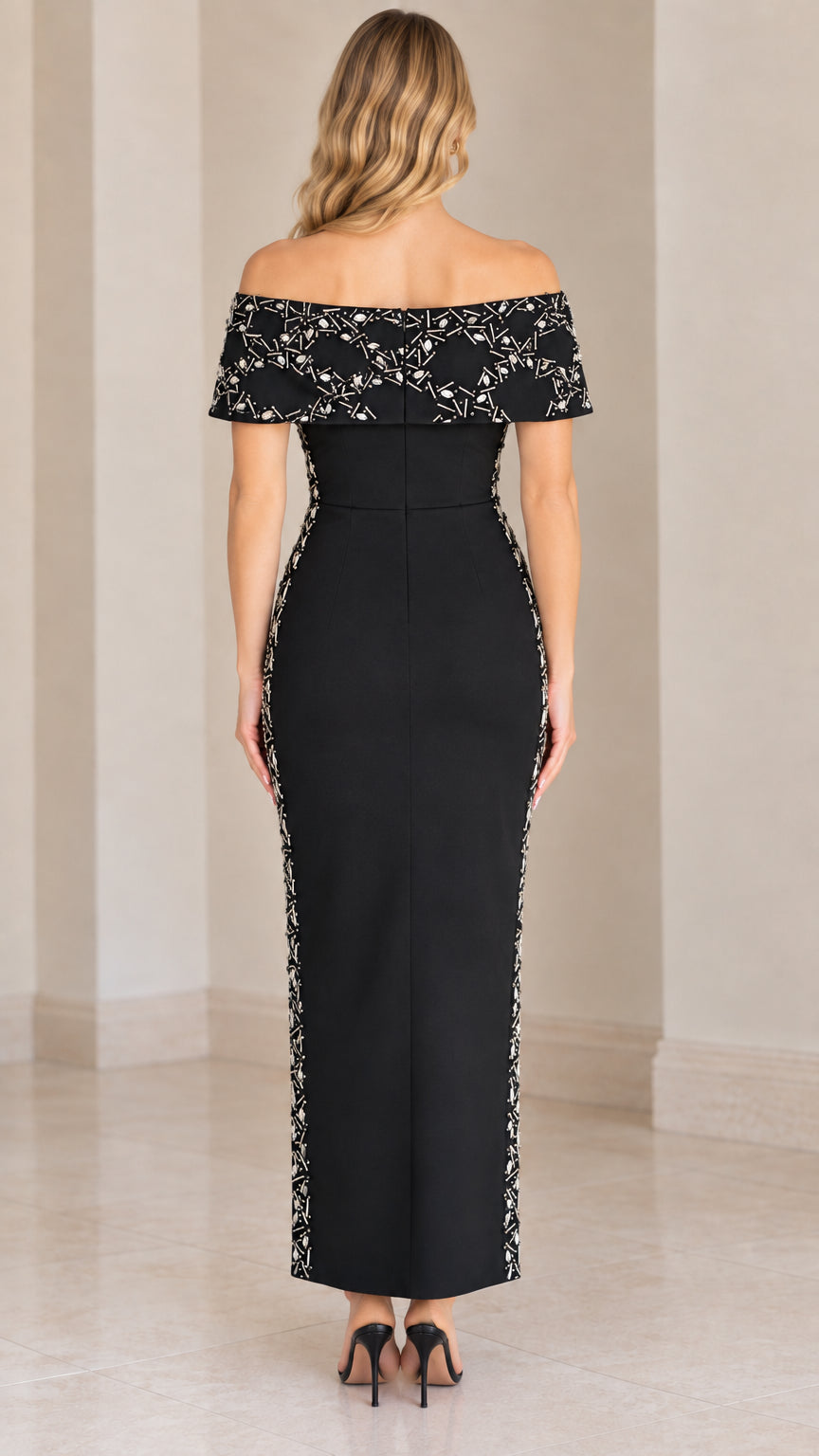 Back view of woman wearing black off-the-shoulder maxi gown with back zip