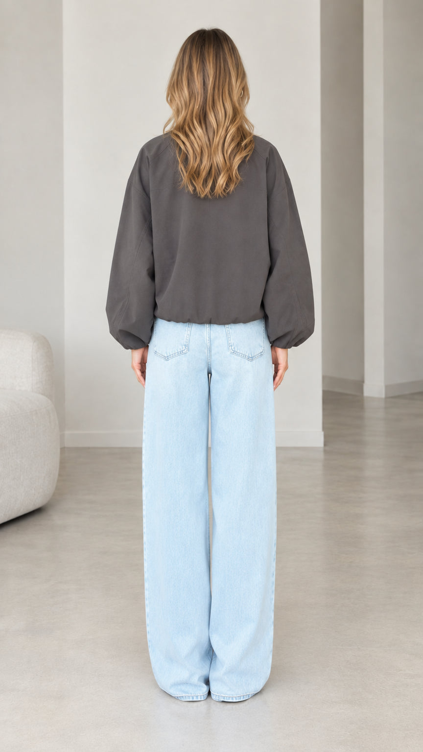 Back view of model wearing Dark Grey gathered hem long sleeve blouse