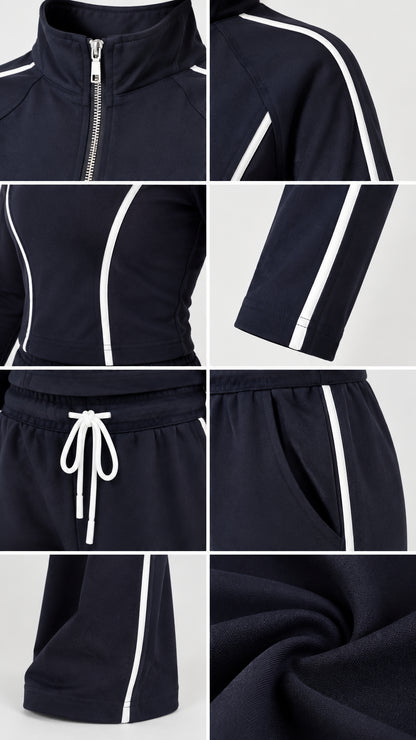 Close-up details of Navy Blue tracksuit zipper, collar, drawstring waistband, pockets, and knit fabric