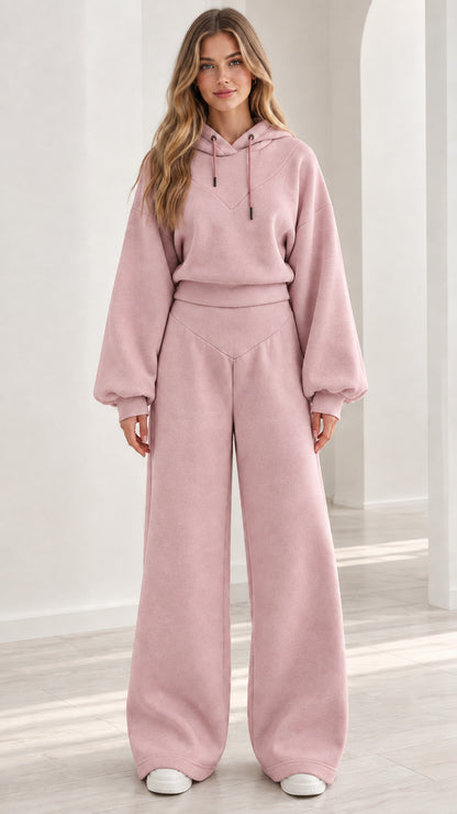 Model wearing dusty pink 2-piece fleece hoodie and wide-leg lounge set