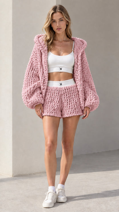 Model wearing dusty pink chunky knit hooded cardigan and matching lounge shorts set