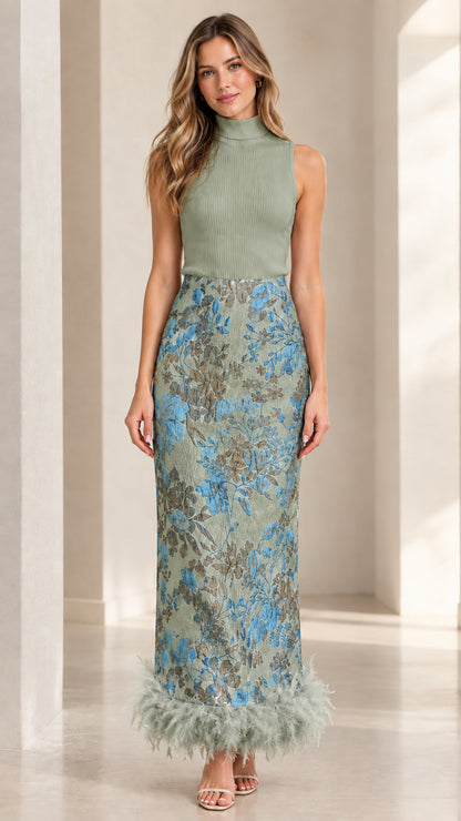 Model wearing Sage Green mock neck knit and floral jacquard dress with matching feather trim