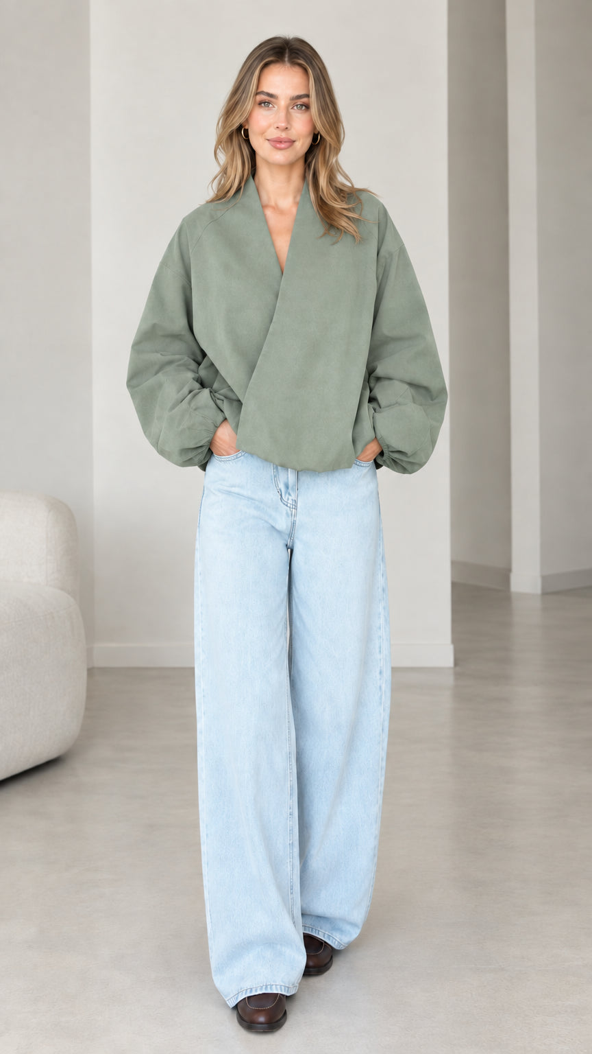 Model wearing Sage Green crossover V-neck balloon sleeve wrap top
