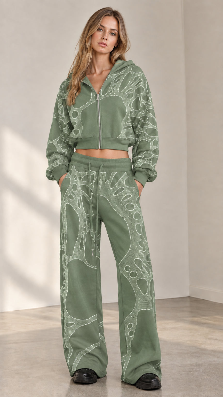 Woman wearing sage green rhinestone cropped zip hoodie and wide leg track pants set