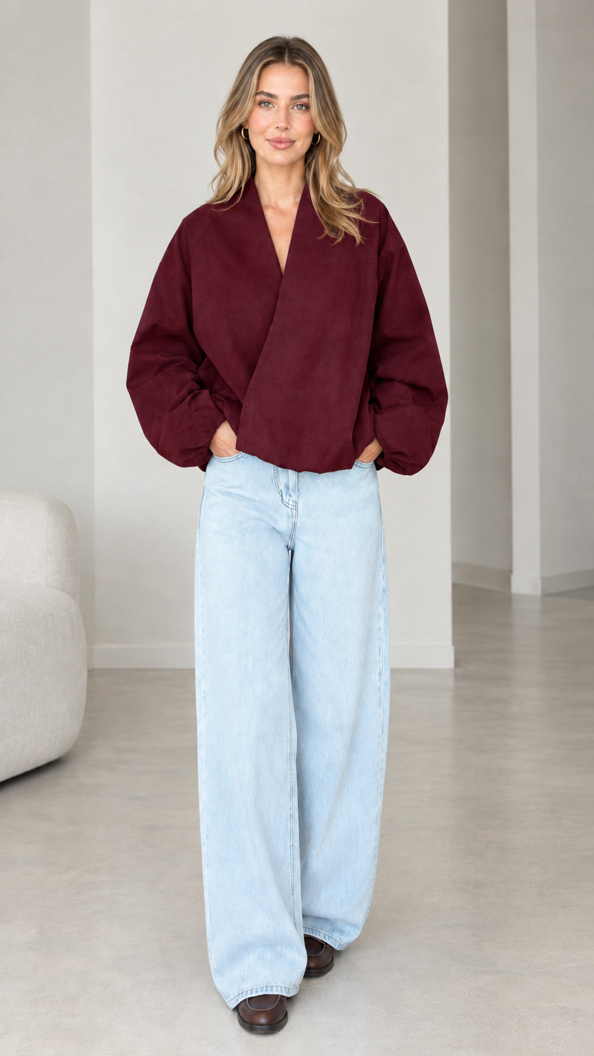 Model wearing Burgundy crossover V-neck balloon sleeve wrap top