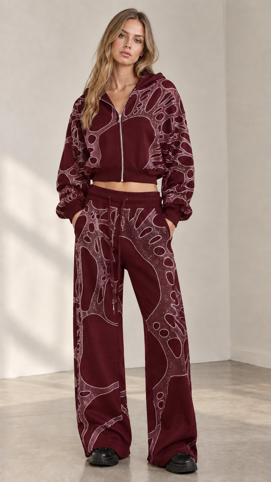 Woman wearing burgundy wine red rhinestone cropped zip hoodie and wide leg sweatpants set
