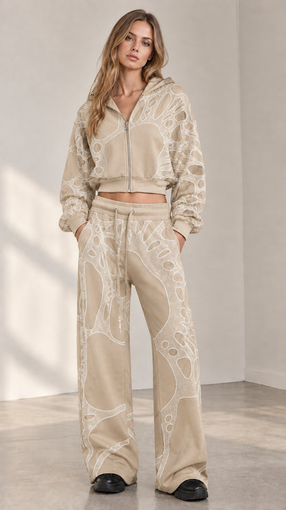 Woman wearing beige oatmeal rhinestone cropped zip hoodie and wide leg sweatpants set