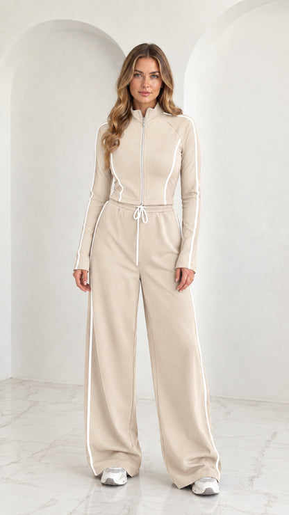 Full front view of model wearing Beige 2-piece zip-up tracksuit set with white piping